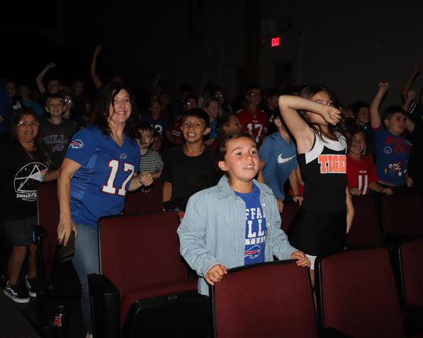 Students and Mrs. Lamont participate in assembly