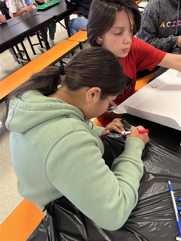Students coloring puzzle pieces
