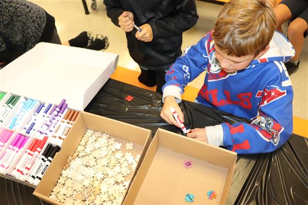 Student coloring puzzle piece