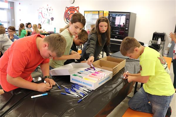 Students coloring puzzle pieces