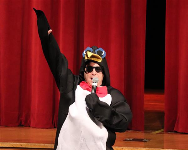 Mr. Esposito, dress as a penguin, welcomes everyone