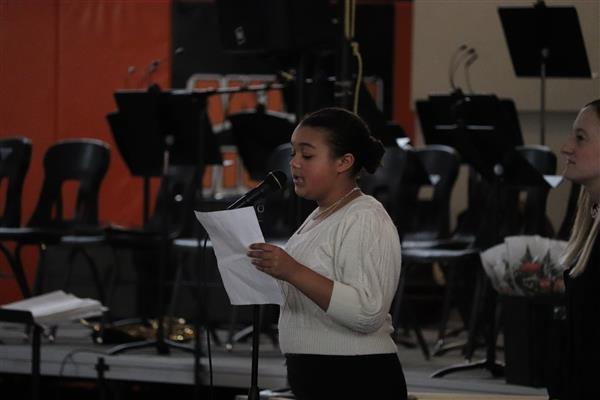 Student introducing musical number