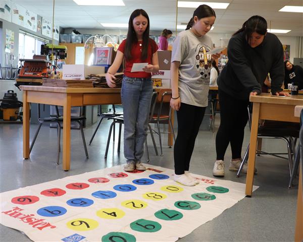 Students work through challenge on game board