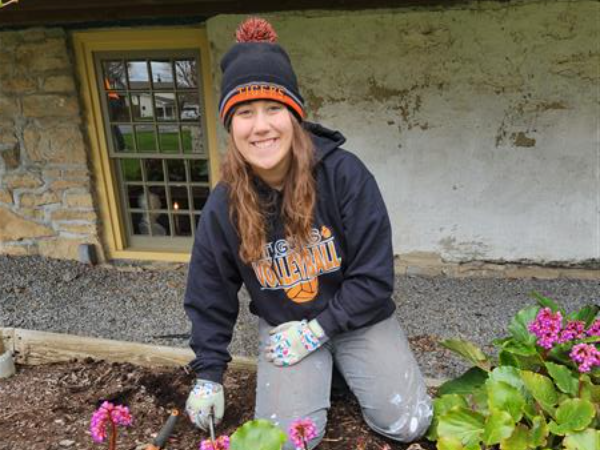 Muira digging weeds