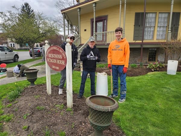 Thumbs up from Kenan and the guys clearing weeds near the sign