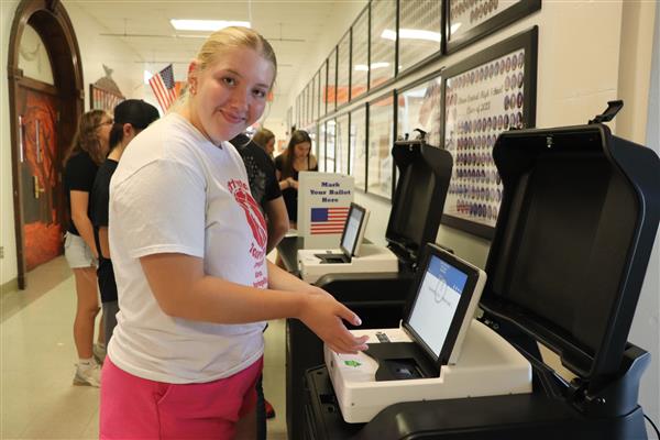 Student entering ballot in machine