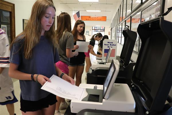 Student submits her ballot