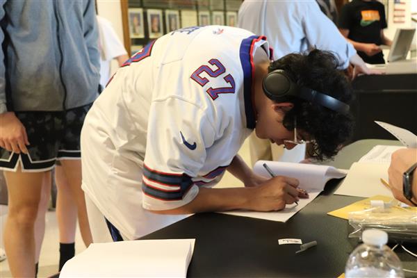 Student signing for ballot