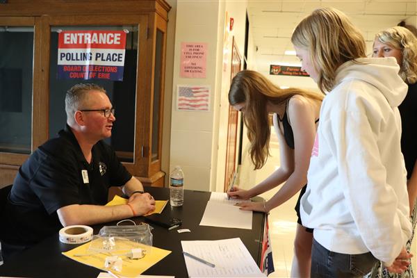 Mr. Rooney assists students