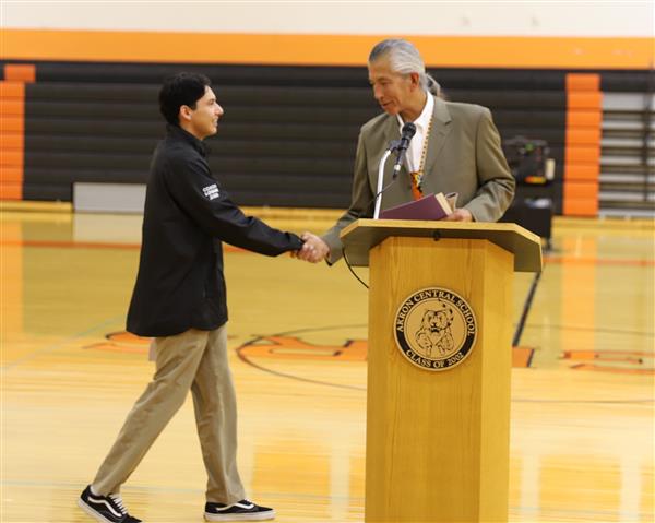 Nelson shakes hand with Coach/Uncle Gary