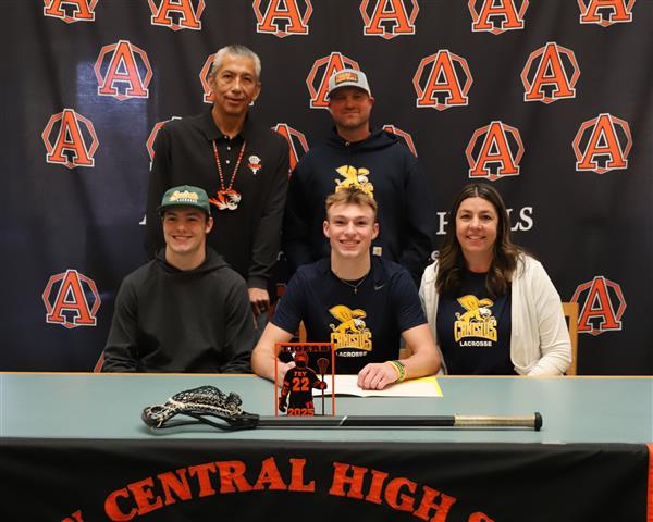 Nick with parents, brother, and Coach Sundown