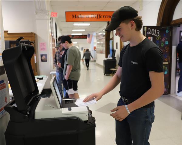 student at voting scanner