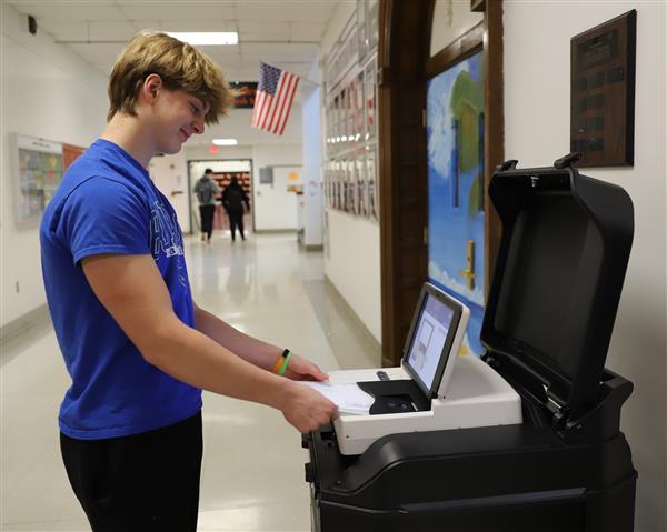 student at voting scanner