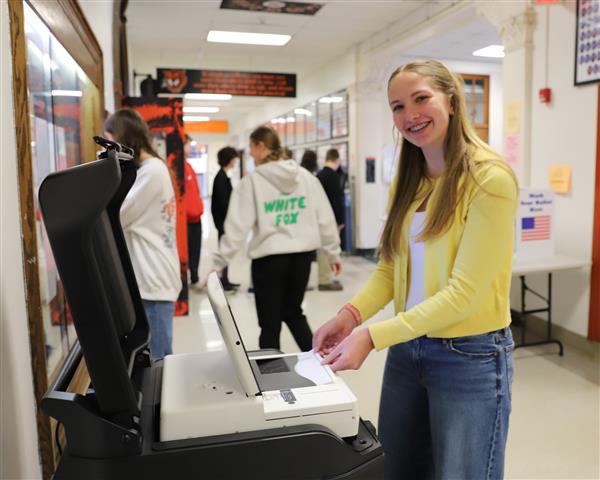 student at voting scanner