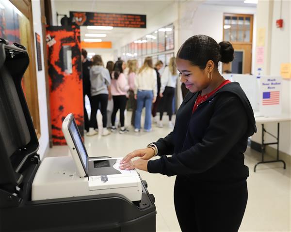 student at voting scanner