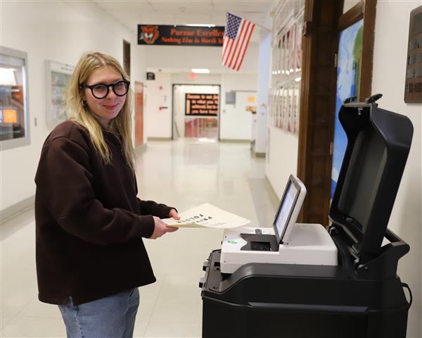 student at voting scanner