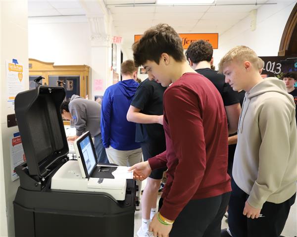 student at voting scanner