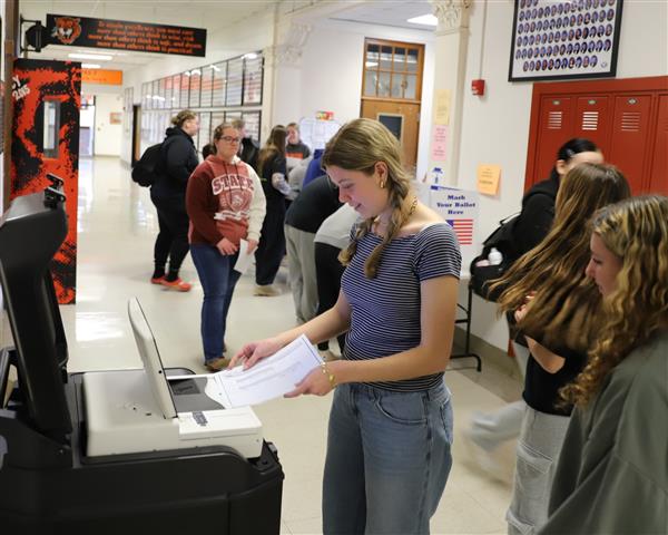student at voting scanner